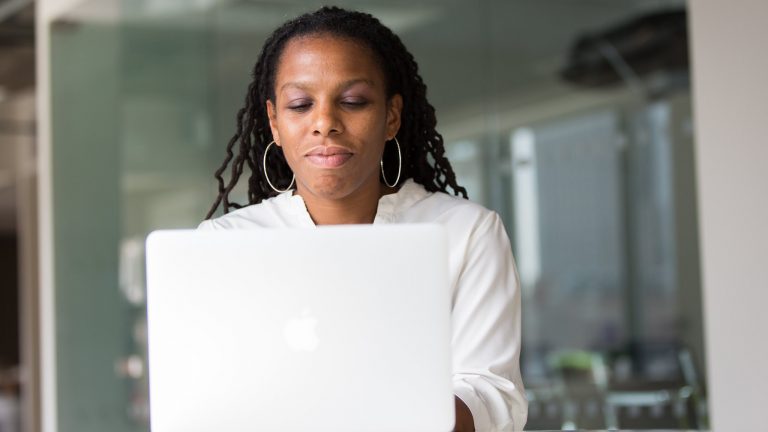 Black woman on a MacBook