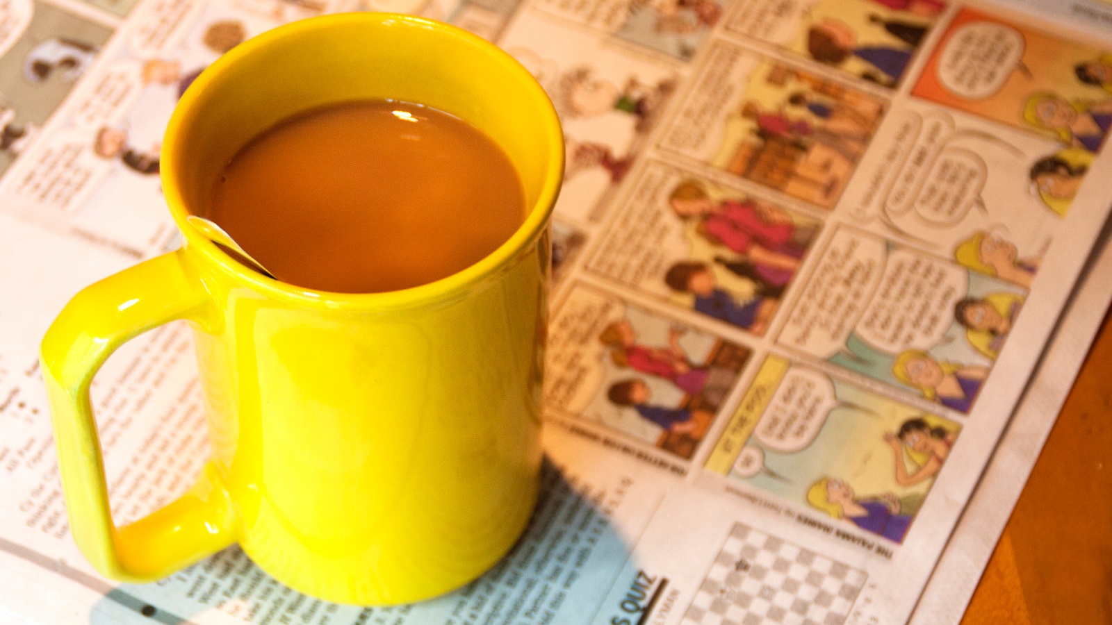 Coffee mug on newspaper comics