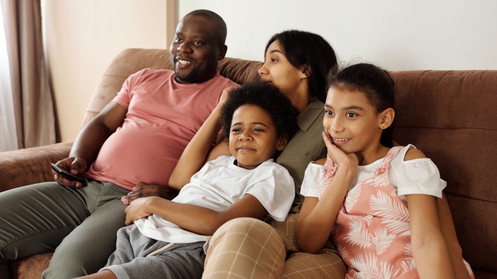 People of color family watching TV