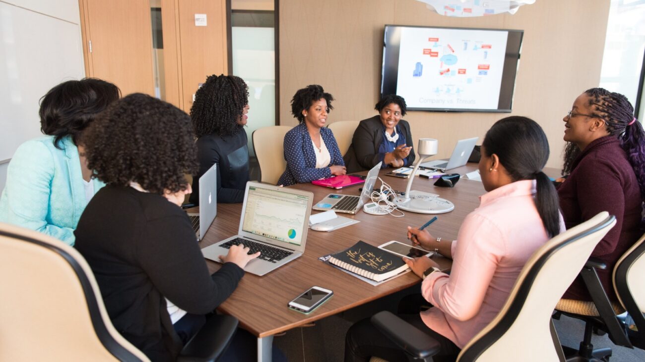 Women of color in tech in a conference room