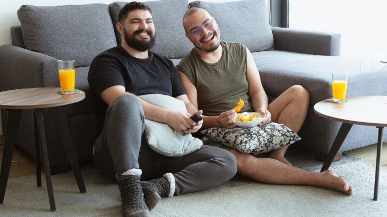 Gay Latino couple watching TV