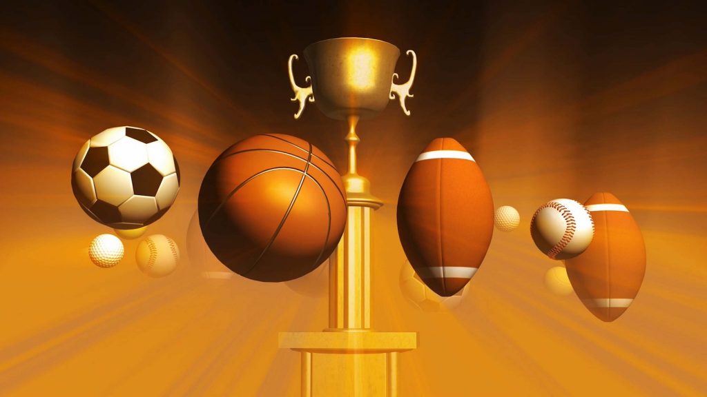 Various sports balls and a trophy