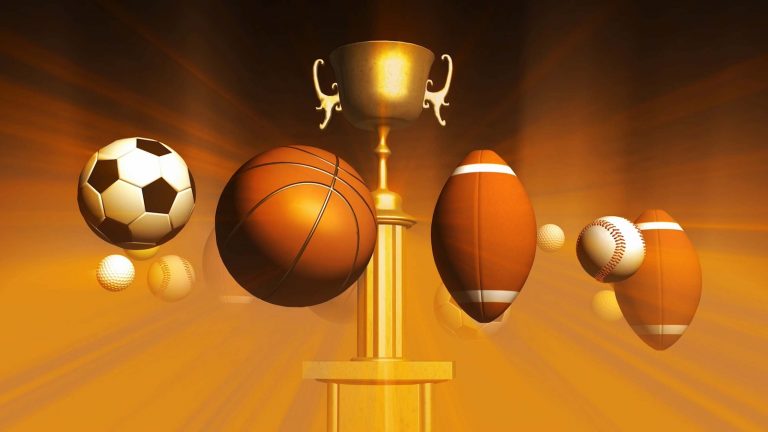 Various sports balls and a trophy
