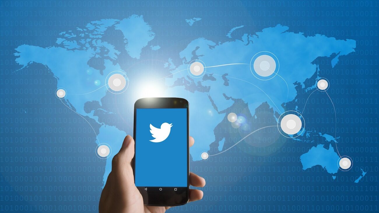 Twitter on smartphone in front of map