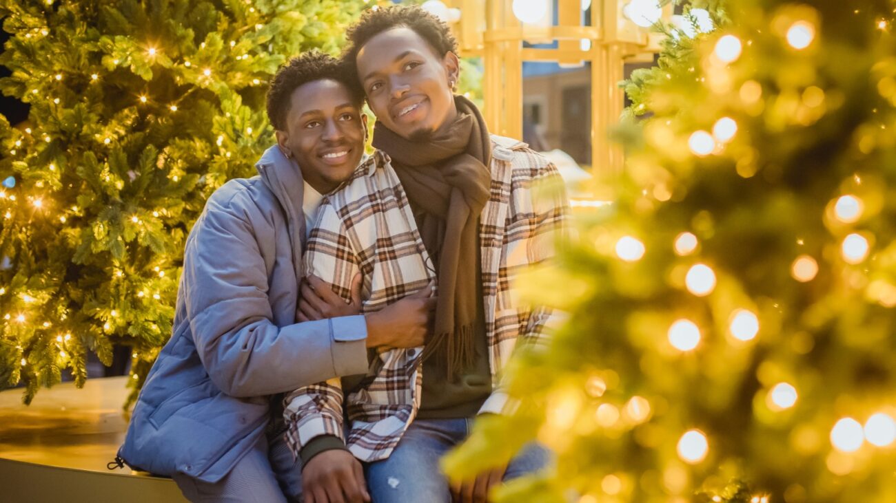 Black gay couple looking at Christmas trees