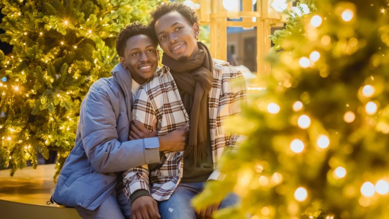 Black gay couple looking at Christmas trees